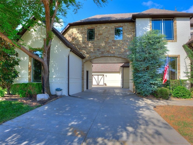 4109 Slate Bridge Rd, Edmond, OK 73034 - view of front of property with driveway, a garage, brick siding, and stone siding