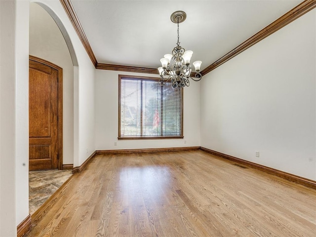 4109 Slate Bridge Rd, Edmond, OK 73034 - spare room featuring arched walkways, a chandelier, crown molding, and wood finished floors