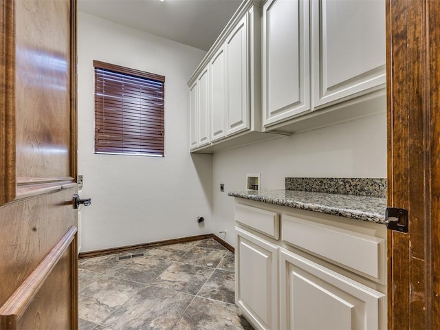 4109 Slate Bridge Rd, Edmond, OK 73034 - laundry area featuring electric dryer hookup, cabinet space, washer hookup, and stone finish flooring