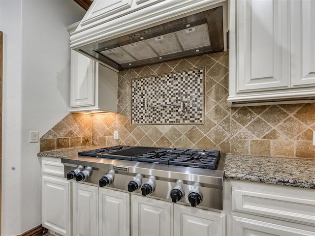 4109 Slate Bridge Rd, Edmond, OK 73034 - kitchen with custom exhaust hood, stainless steel gas cooktop, white cabinets, tasteful backsplash, and stone counters