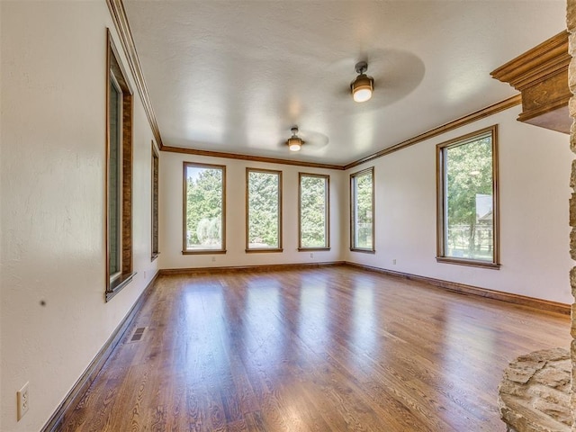 4109 Slate Bridge Rd, Edmond, OK 73034 - unfurnished room featuring crown molding, wood finished floors, and a ceiling fan