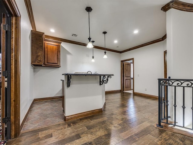 4109 Slate Bridge Rd, Edmond, OK 73034 - kitchen featuring ornamental molding, dark wood-style flooring, pendant lighting, recessed lighting, and brown cabinets