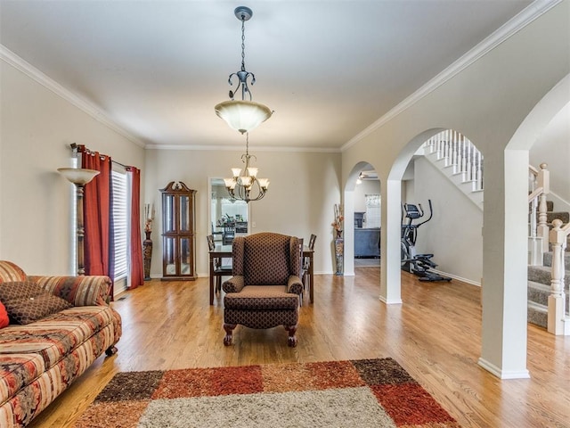 7300 NW 109th St, Oklahoma City, OK 73162 - living room featuring arched walkways, light wood-style floors, a chandelier, crown molding, and stairway