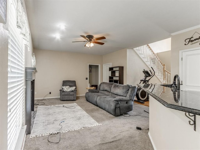 7300 NW 109th St, Oklahoma City, OK 73162 - carpeted living room with stairs, ceiling fan, a fireplace, and ornamental molding