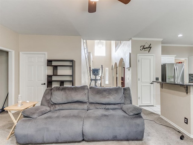 7300 NW 109th St, Oklahoma City, OK 73162 - living room featuring arched walkways, a ceiling fan, light colored carpet, and ornamental molding