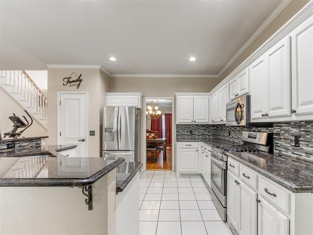 7300 NW 109th St, Oklahoma City, OK 73162 - kitchen featuring appliances with stainless steel finishes, a chandelier, decorative backsplash, light tile patterned flooring, and white cabinets