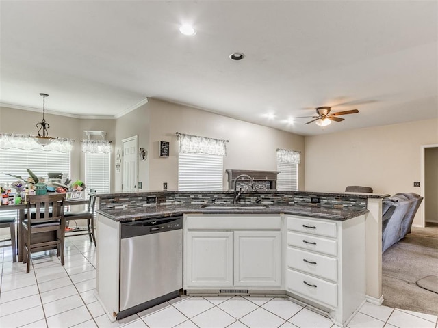 7300 NW 109th St, Oklahoma City, OK 73162 - kitchen with stainless steel dishwasher, a ceiling fan, dark stone countertops, open floor plan, and white cabinetry