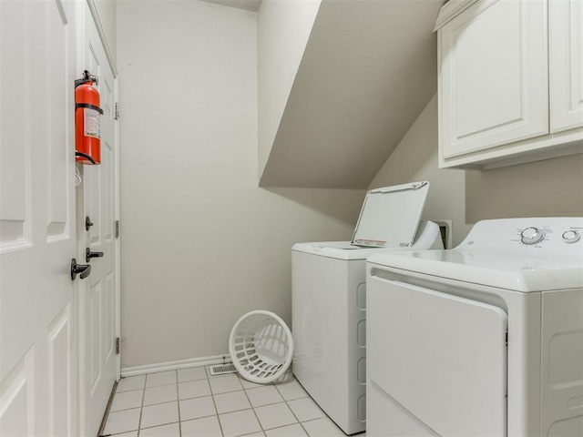7300 NW 109th St, Oklahoma City, OK 73162 - washroom with cabinet space, separate washer and dryer, and light tile patterned flooring