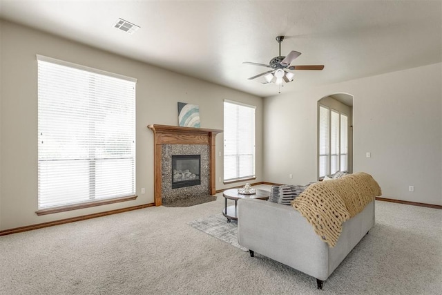3000 Hampshire Ln, Oklahoma City, OK 73179 - living room featuring ceiling fan, carpet floors, arched walkways, and a tile fireplace