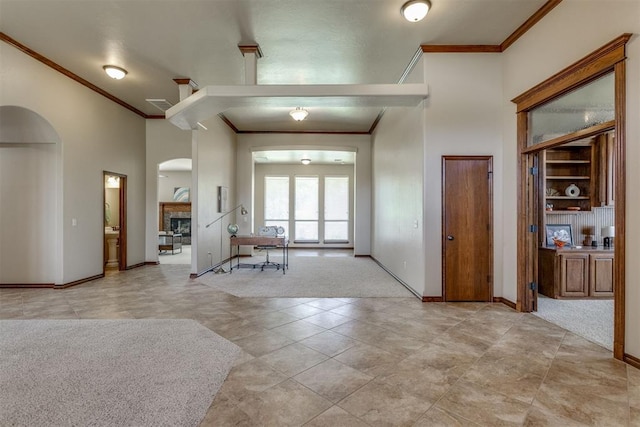 3000 Hampshire Ln, Oklahoma City, OK 73179 - entrance foyer featuring crown molding, arched walkways, a towering ceiling, and light tile patterned flooring