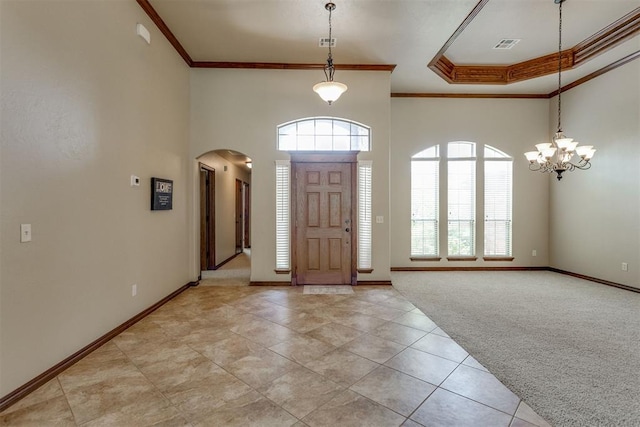 3000 Hampshire Ln, Oklahoma City, OK 73179 - entryway with ornamental molding, healthy amount of natural light, a towering ceiling, arched walkways, and light tile patterned floors