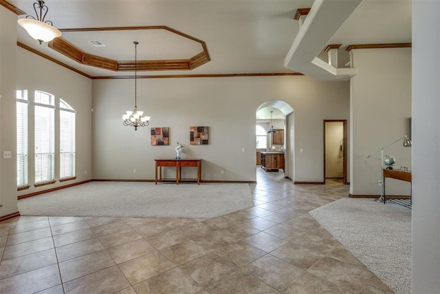 3000 Hampshire Ln, Oklahoma City, OK 73179 - spare room featuring crown molding, arched walkways, light tile patterned flooring, a chandelier, and a tray ceiling