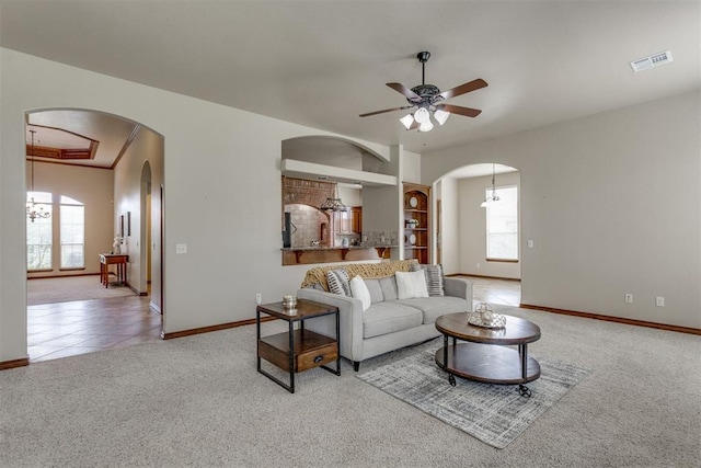 3000 Hampshire Ln, Oklahoma City, OK 73179 - carpeted living room featuring arched walkways, healthy amount of natural light, and ceiling fan