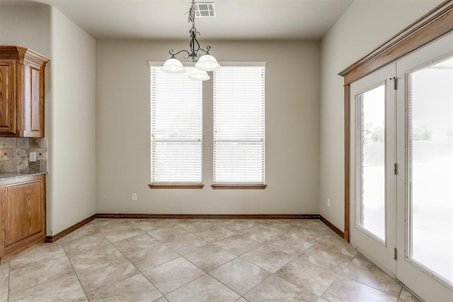 3000 Hampshire Ln, Oklahoma City, OK 73179 - unfurnished dining area featuring healthy amount of natural light, a chandelier, and light tile patterned floors