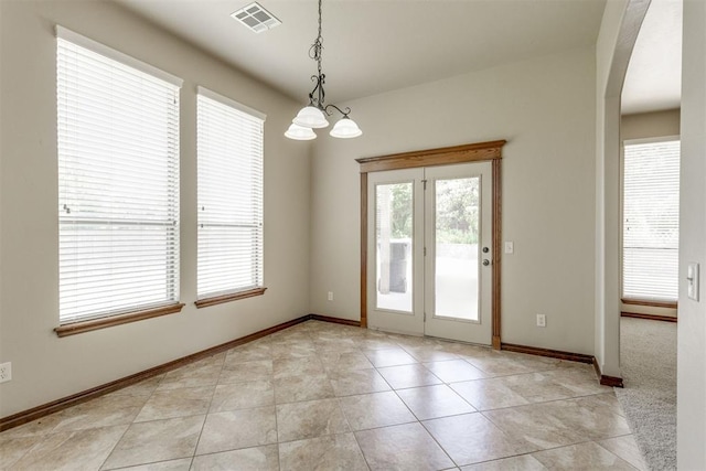 3000 Hampshire Ln, Oklahoma City, OK 73179 - unfurnished dining area featuring plenty of natural light, arched walkways, a chandelier, and light tile patterned flooring