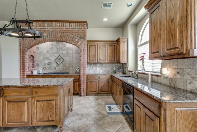 3000 Hampshire Ln, Oklahoma City, OK 73179 - kitchen featuring backsplash, light stone countertops, and brown cabinets