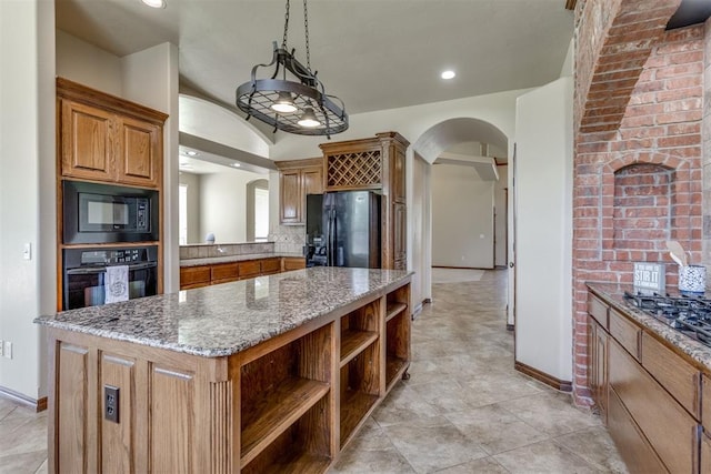 3000 Hampshire Ln, Oklahoma City, OK 73179 - kitchen with black appliances, arched walkways, open shelves, a center island, and brown cabinets