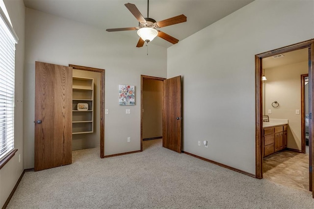 3000 Hampshire Ln, Oklahoma City, OK 73179 - unfurnished bedroom with a high ceiling, light carpet, a walk in closet, connected bathroom, and a ceiling fan