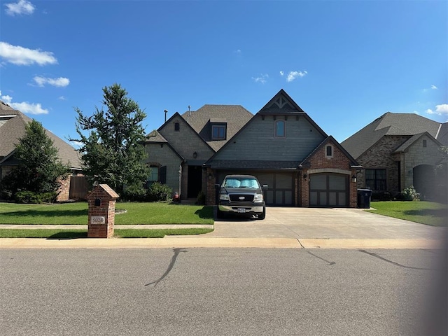 5024 SW 130th St, Oklahoma City, OK 73173 - french provincial home with an attached garage, a front yard, concrete driveway, and brick siding