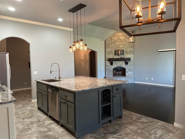 5024 SW 130th St, Oklahoma City, OK 73173 - kitchen with arched walkways, stainless steel appliances, open floor plan, gray cabinetry, and light stone countertops