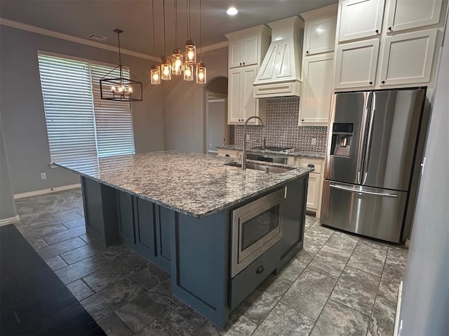 5024 SW 130th St, Oklahoma City, OK 73173 - kitchen with stainless steel appliances, custom range hood, ornamental molding, backsplash, and light stone countertops