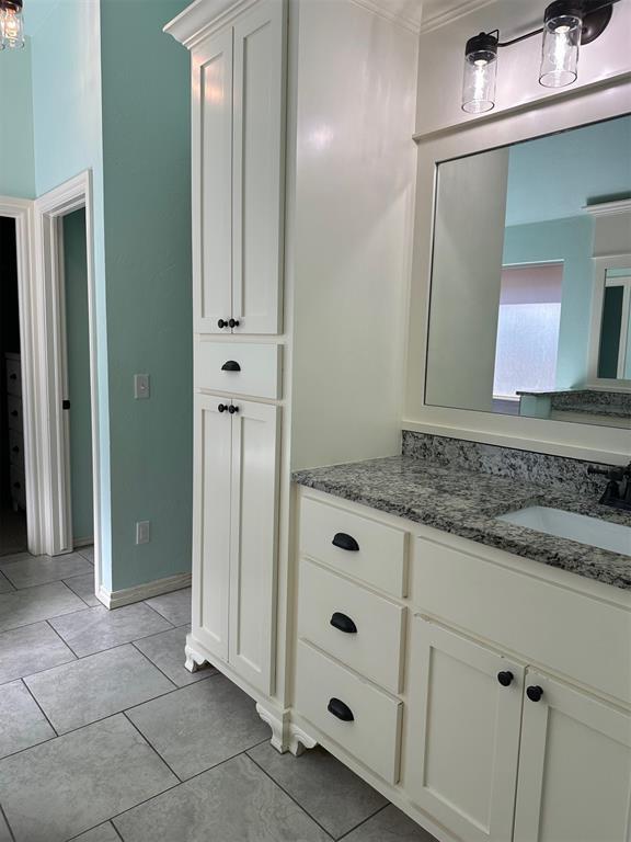 5024 SW 130th St, Oklahoma City, OK 73173 - bathroom with vanity, crown molding, and tile patterned flooring