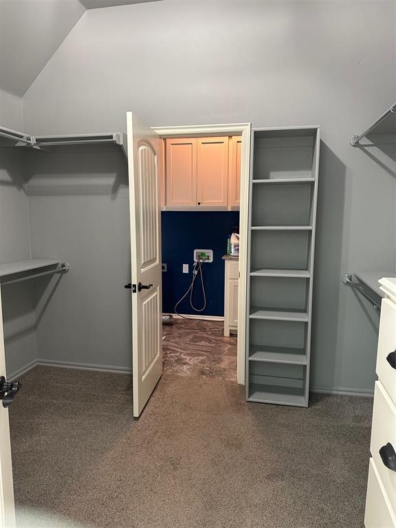 5024 SW 130th St, Oklahoma City, OK 73173 - walk in closet with dark carpet and lofted ceiling
