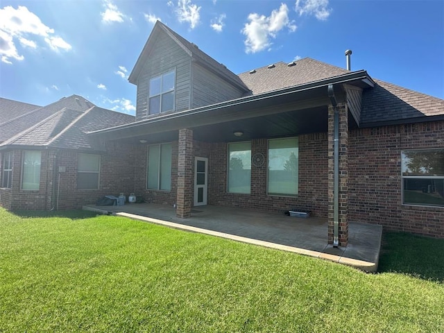 5024 SW 130th St, Oklahoma City, OK 73173 - back of property with a yard, a patio area, and brick siding