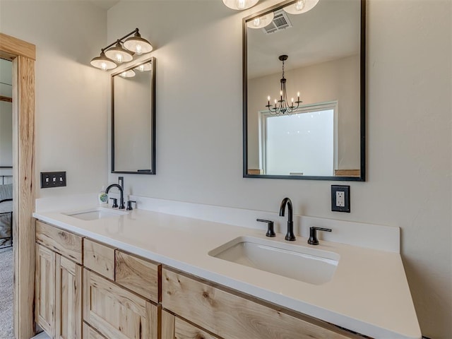 29490 County Road 180th Rd, Stillwater, OK 74075 - bathroom featuring double vanity and a chandelier