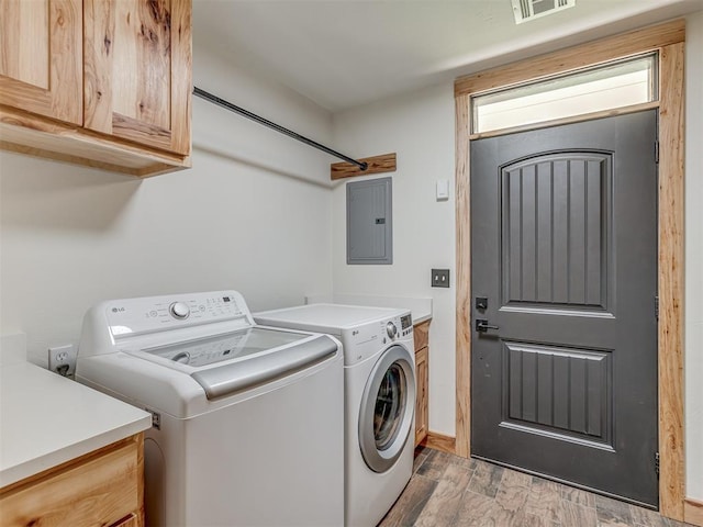29490 County Road 180th Rd, Stillwater, OK 74075 - laundry area with cabinet space, washer and clothes dryer, electric panel, and wood finished floors