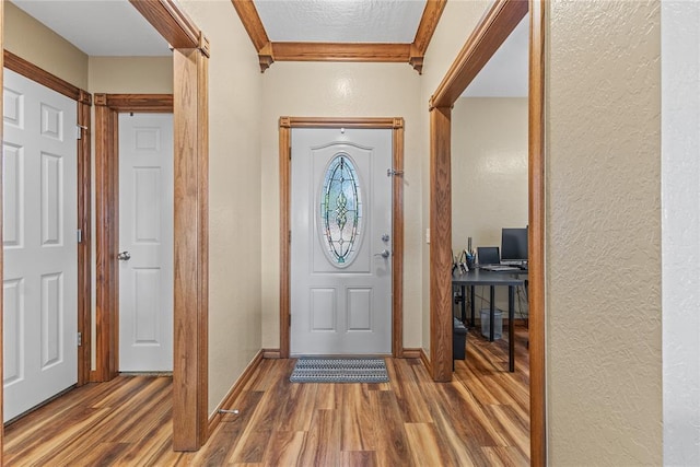 3008 Fairway Dr, Weatherford, OK 73096 - foyer entrance with a textured wall, wood finished floors, and ornamental molding