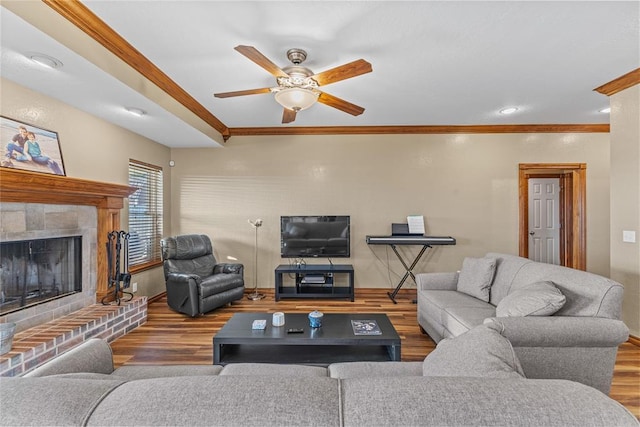 3008 Fairway Dr, Weatherford, OK 73096 - living area featuring ornamental molding, wood finished floors, a ceiling fan, and a brick fireplace