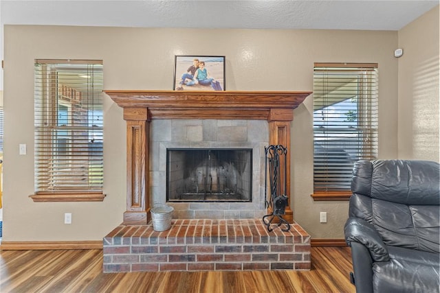 3008 Fairway Dr, Weatherford, OK 73096 - detailed view of wood finished floors and a fireplace with raised hearth