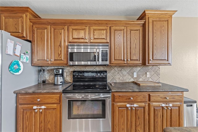 3008 Fairway Dr, Weatherford, OK 73096 - kitchen with stainless steel appliances, dark countertops, backsplash, and brown cabinets