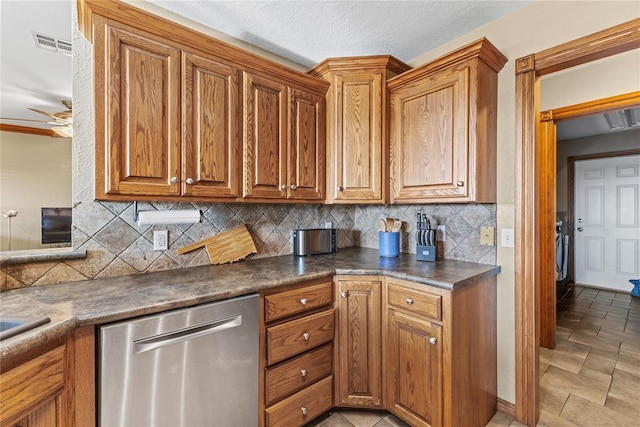 3008 Fairway Dr, Weatherford, OK 73096 - kitchen with stainless steel dishwasher, dark countertops, backsplash, and brown cabinets