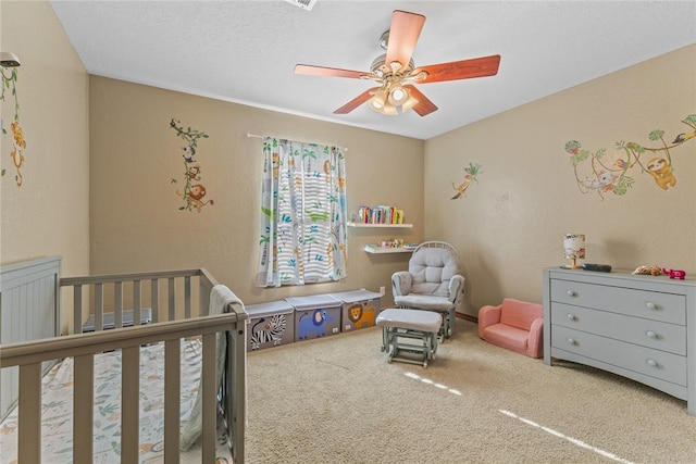 3008 Fairway Dr, Weatherford, OK 73096 - bedroom with a crib, carpet flooring, and ceiling fan