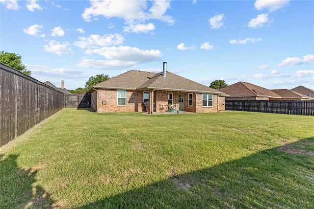 3008 Fairway Dr, Weatherford, OK 73096 - back of house with brick siding, a fenced backyard, roof with shingles, and a patio area