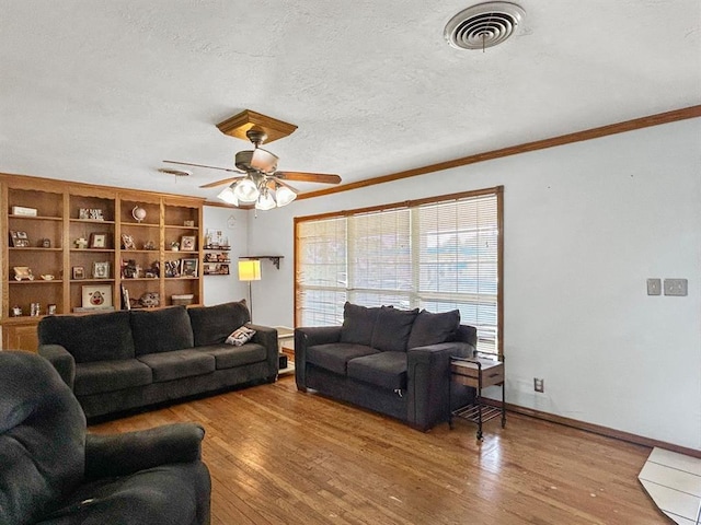 521 E Broadway St, Lexington, OK 73051 - living room with crown molding, wood finished floors, a ceiling fan, and a textured ceiling