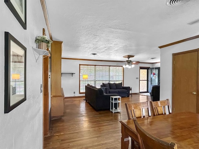 521 E Broadway St, Lexington, OK 73051 - dining area with crown molding, wood finished floors, a textured ceiling, and ceiling fan
