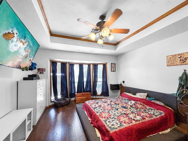 521 E Broadway St, Lexington, OK 73051 - bedroom featuring a raised ceiling, wood finished floors, ornamental molding, ceiling fan, and a textured ceiling