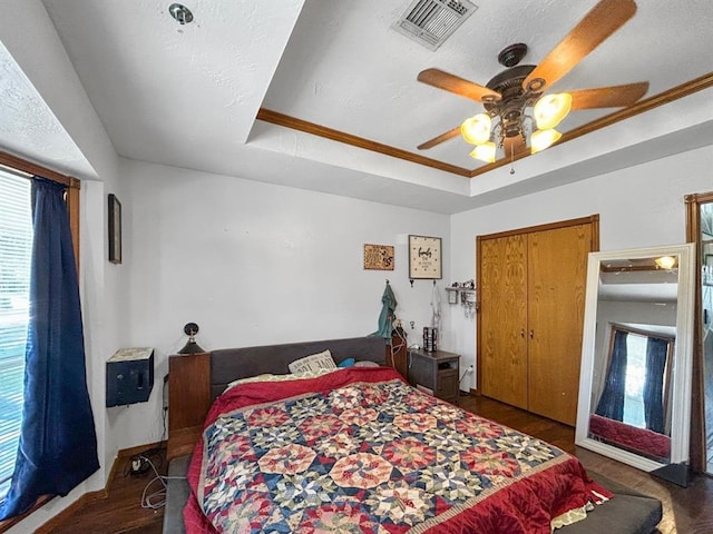 521 E Broadway St, Lexington, OK 73051 - bedroom with multiple windows, a raised ceiling, ceiling fan, crown molding, and wood finished floors