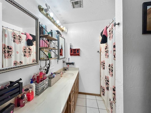 521 E Broadway St, Lexington, OK 73051 - full bathroom with vanity, tile patterned floors, a textured ceiling, a shower with shower curtain, and a textured wall