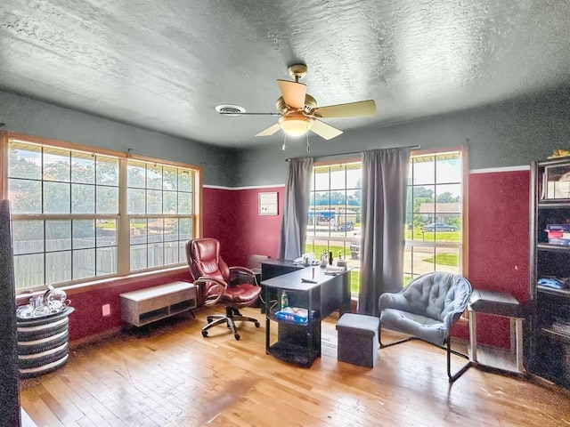 521 E Broadway St, Lexington, OK 73051 - office with wood-type flooring, a ceiling fan, a textured ceiling, and a textured wall