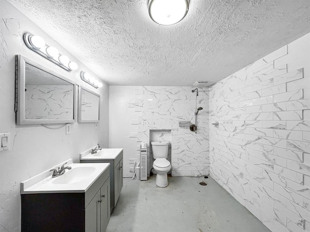 521 E Broadway St, Lexington, OK 73051 - bathroom with finished concrete flooring, tiled shower, two vanities, and a textured ceiling