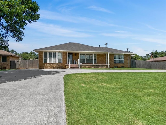 521 E Broadway St, Lexington, OK 73051 - ranch-style house featuring driveway, covered porch, and brick siding