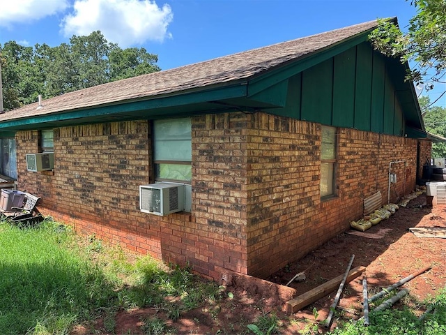 28197 Buck Townes Rd, Macomb, OK 74852 - view of side of property with board and batten siding, brick siding, roof with shingles, and cooling unit