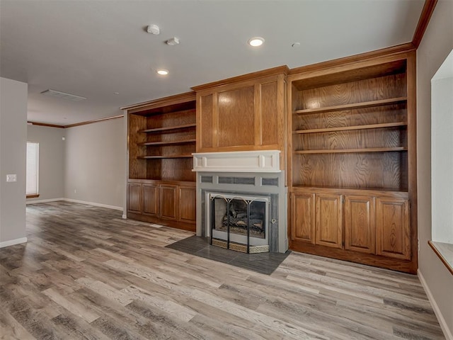 11300 N Pennsylvania Ave Unit 120, Oklahoma City, OK 73120 - unfurnished living room with crown molding, light wood-style floors, a fireplace with flush hearth, and recessed lighting