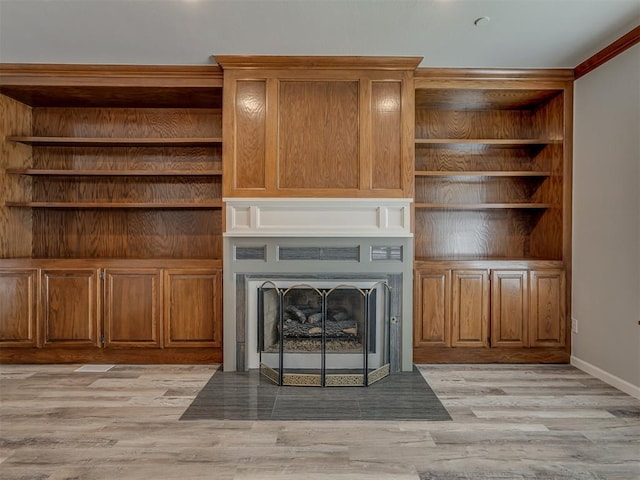 11300 N Pennsylvania Ave Unit 120, Oklahoma City, OK 73120 - unfurnished living room featuring light wood finished floors and a fireplace with flush hearth