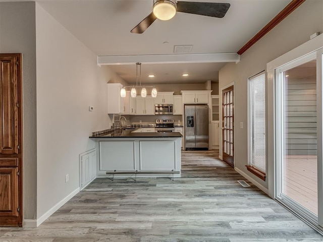 11300 N Pennsylvania Ave Unit 120, Oklahoma City, OK 73120 - kitchen featuring appliances with stainless steel finishes, dark countertops, a ceiling fan, white cabinets, and light wood-type flooring