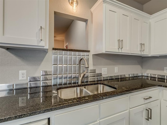 11300 N Pennsylvania Ave Unit 120, Oklahoma City, OK 73120 - kitchen with white cabinets, dark stone countertops, and a textured wall